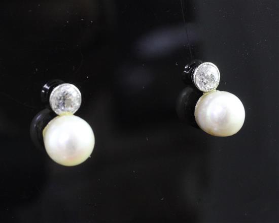 A pair of white gold, cultured pearl and single stone diamond earrings.